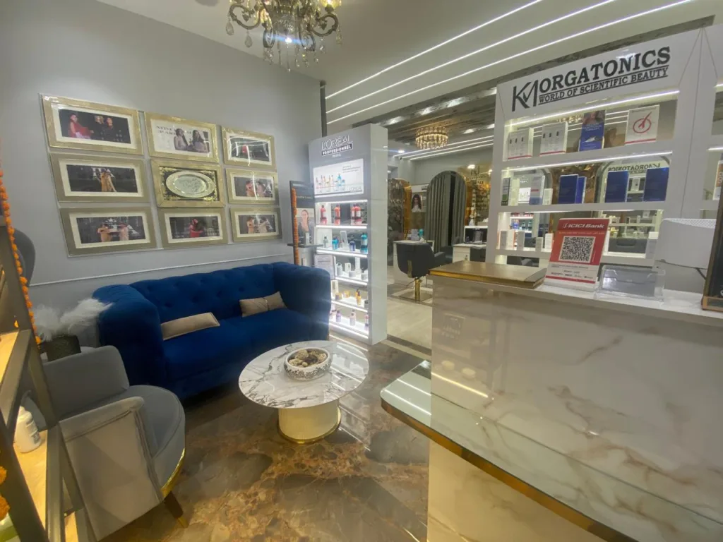 The luxurious waiting area at KM Orgatonics in Gorakhpur, featuring plush seating, elegant decor, and a display of beauty products.