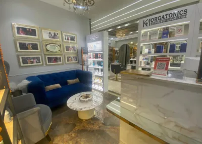 The luxurious waiting area at KM Orgatonics in Gorakhpur, featuring plush seating, elegant decor, and a display of beauty products.