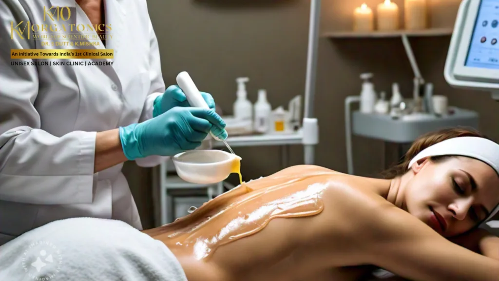 Close-up of glowing, hydrated skin with water droplets on a person's shoulder and a creamy skincare product applied to their face. KM Orgatonics provides scientific beauty treatments.